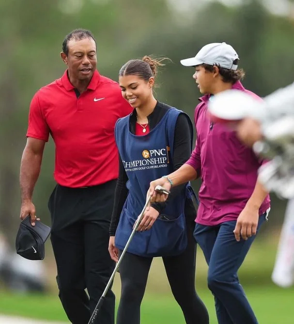 Charlie Woods with his dad and sister