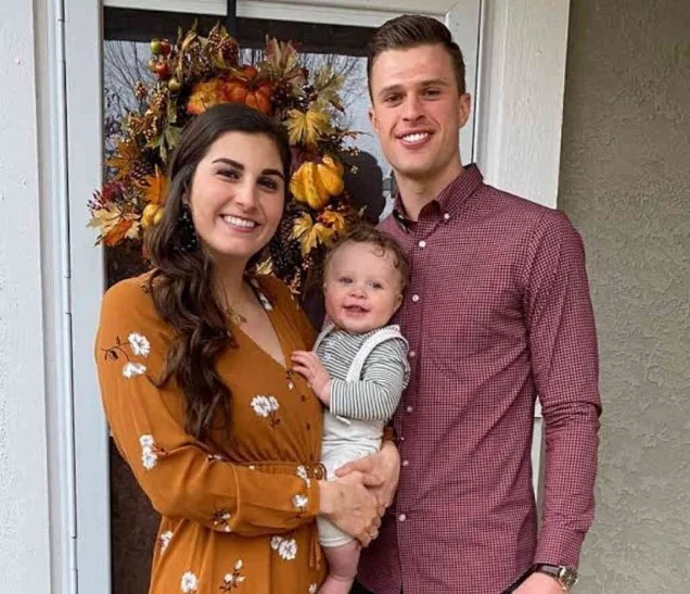 Isabelle Butker with her husband and son