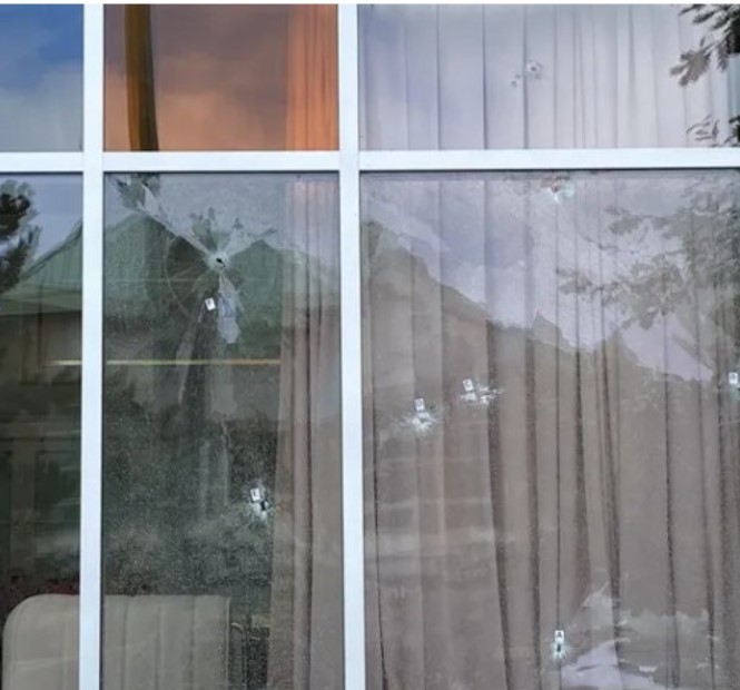 A picture of multiple bullets fired on the window of Kap’s Cafe