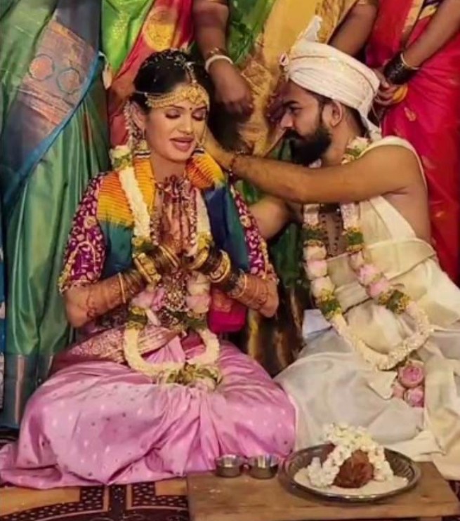 Chaitra Kundapur and her husband's wedding image