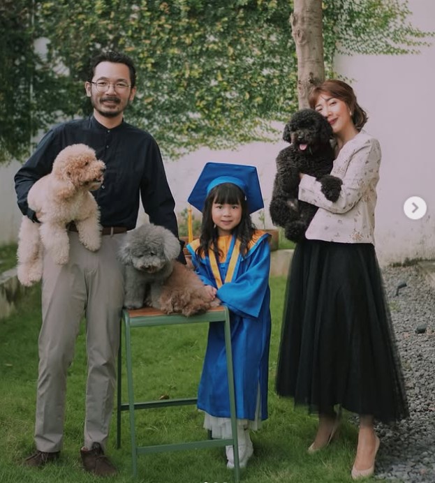 Claradevi Handriatmadja with her husband, son and dogs